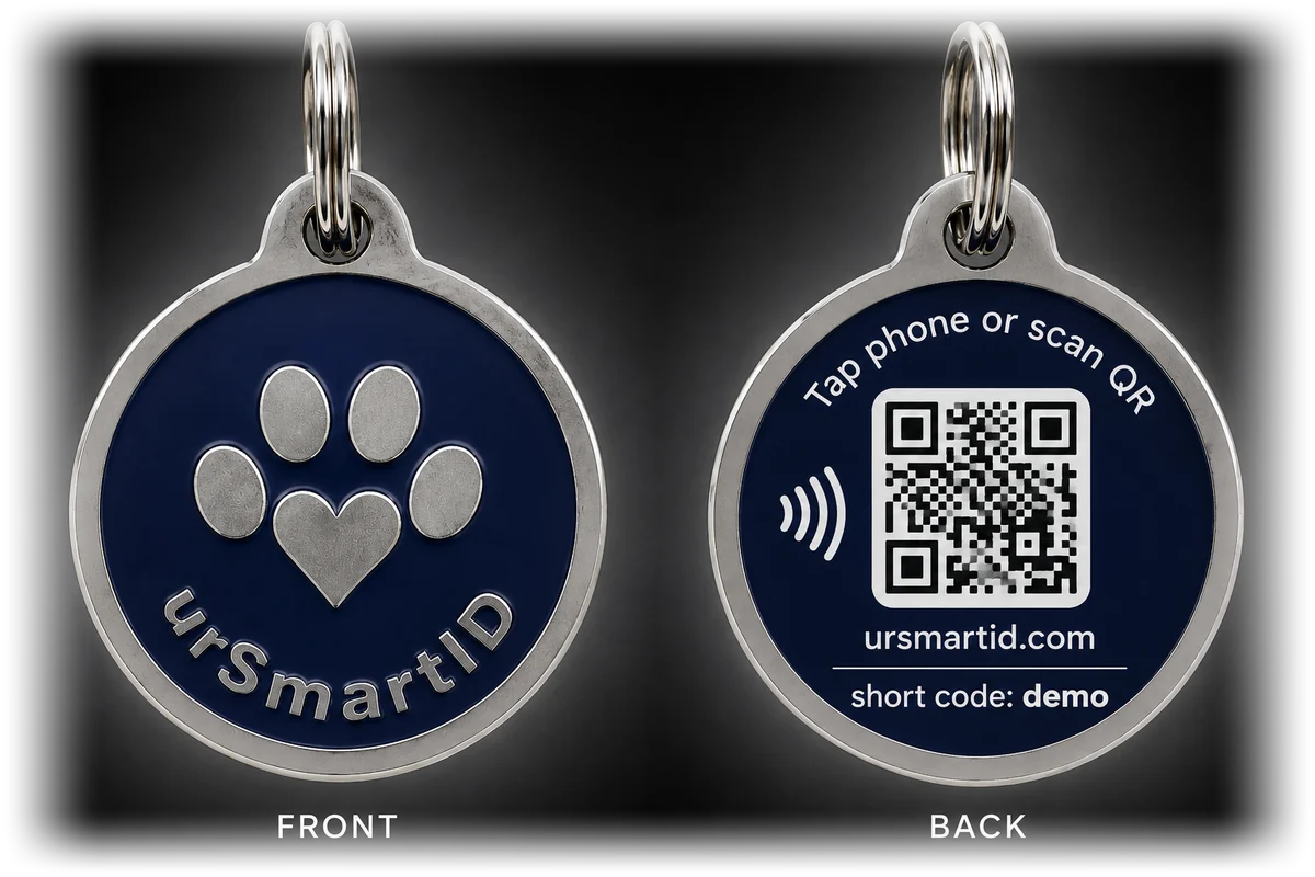 The urSmartID tag, shown front and back. The front is navy enamel with a raised steel paw-and-heart mark above the urSmartID name; the back carries a QR code, a contactless symbol, ursmartid.com and the tag's short code.